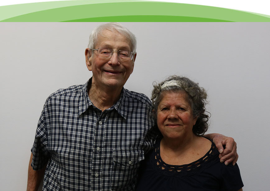 An older man and women are very happy that they were able to take advantage of the social services and advocacy services offered by Chicago Hearing Society.