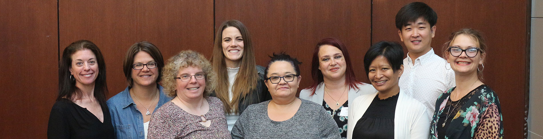 A group of Chicago Hearing Society employees, all smiling, and looking forward to meeting you.